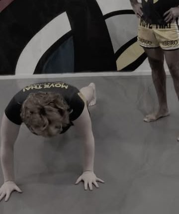 Aluna em exercício funcional no chão durante aula Prime Move